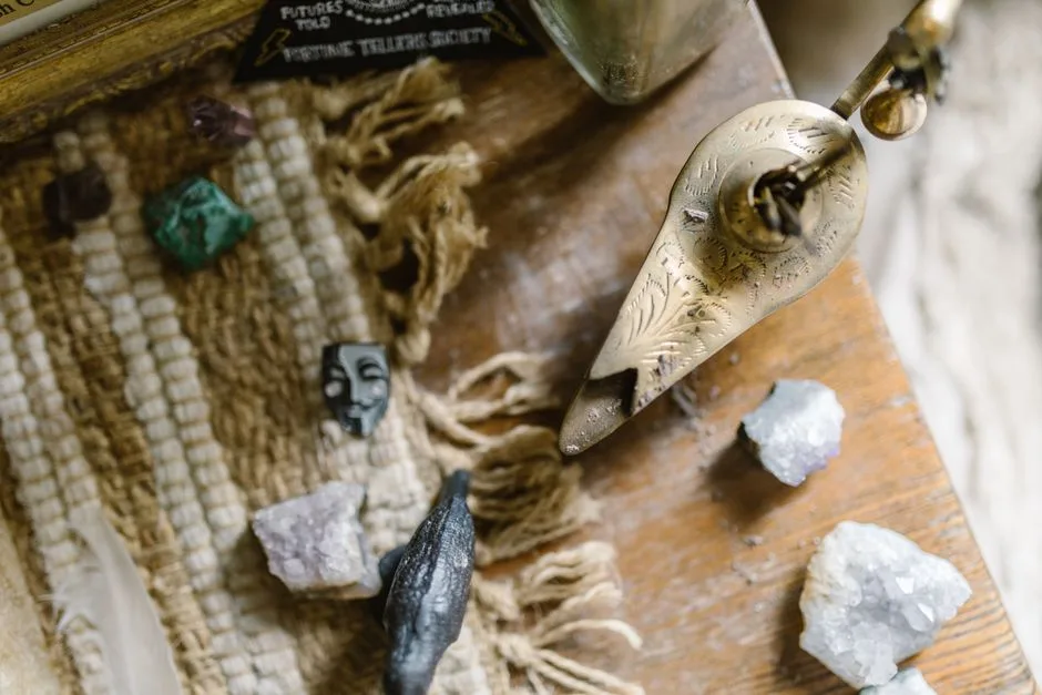 Close-up of crystals, an ornate incense holder, and textured fabric for healing and energy practices.
