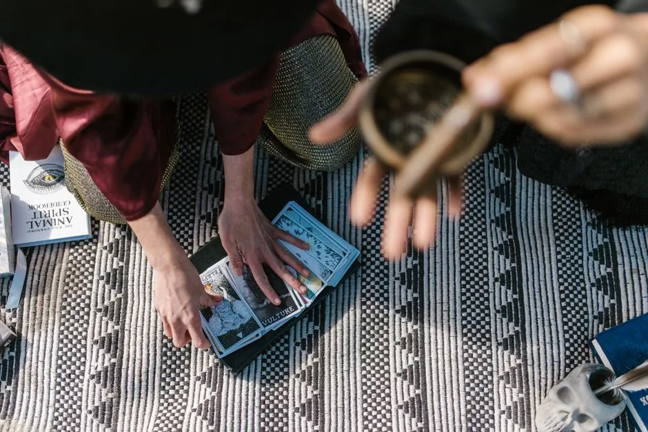 A serene setup for an intimate tarot card reading ceremony with incense and spiritual books.