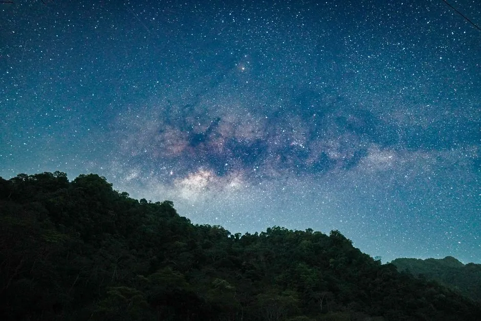 Stunning night view of the Milky Way over lush hills in Jepara, Indonesia.