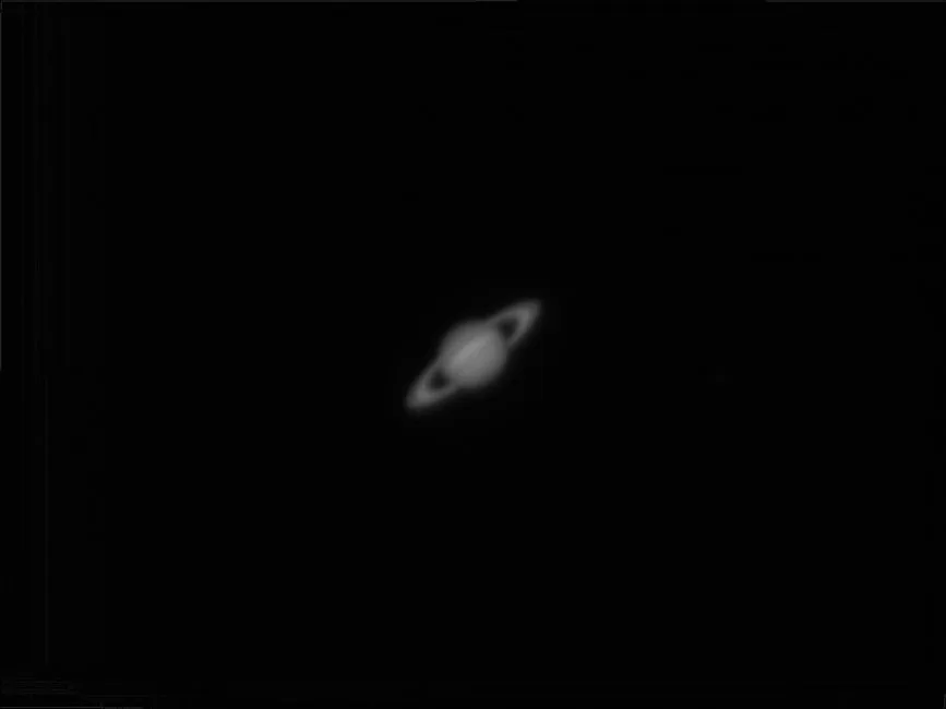 A captivating black and white photograph of Saturn showcasing its iconic rings.