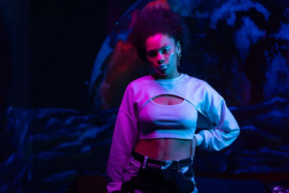 Stylish woman posing in a vibrant, neon-lit club setting. A modern and confident portrait.